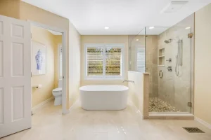 Bright bathroom with tub, vanity, and divided layout