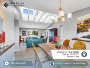 Bright dining area leading to a cozy living room, featuring skylights and contemporary finishes