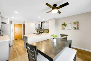 Remodeled kitchen with island, stainless appliances, and dining table