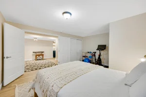 Basement transformation by Springs Home Improvement with cozy room and fitness area