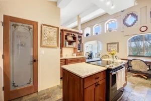 Custom kitchen with pantry door and built-in desk area